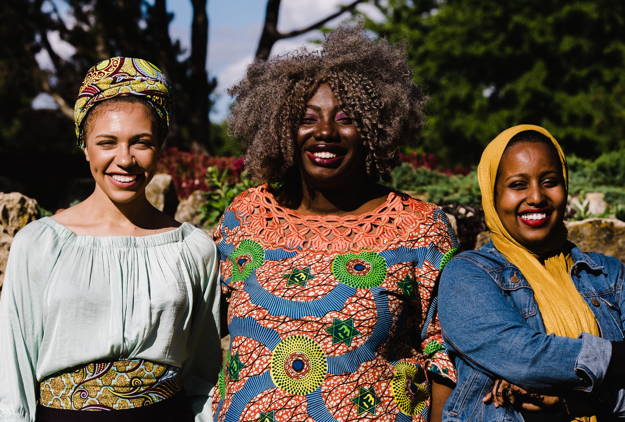 Three women smiling together outdoors